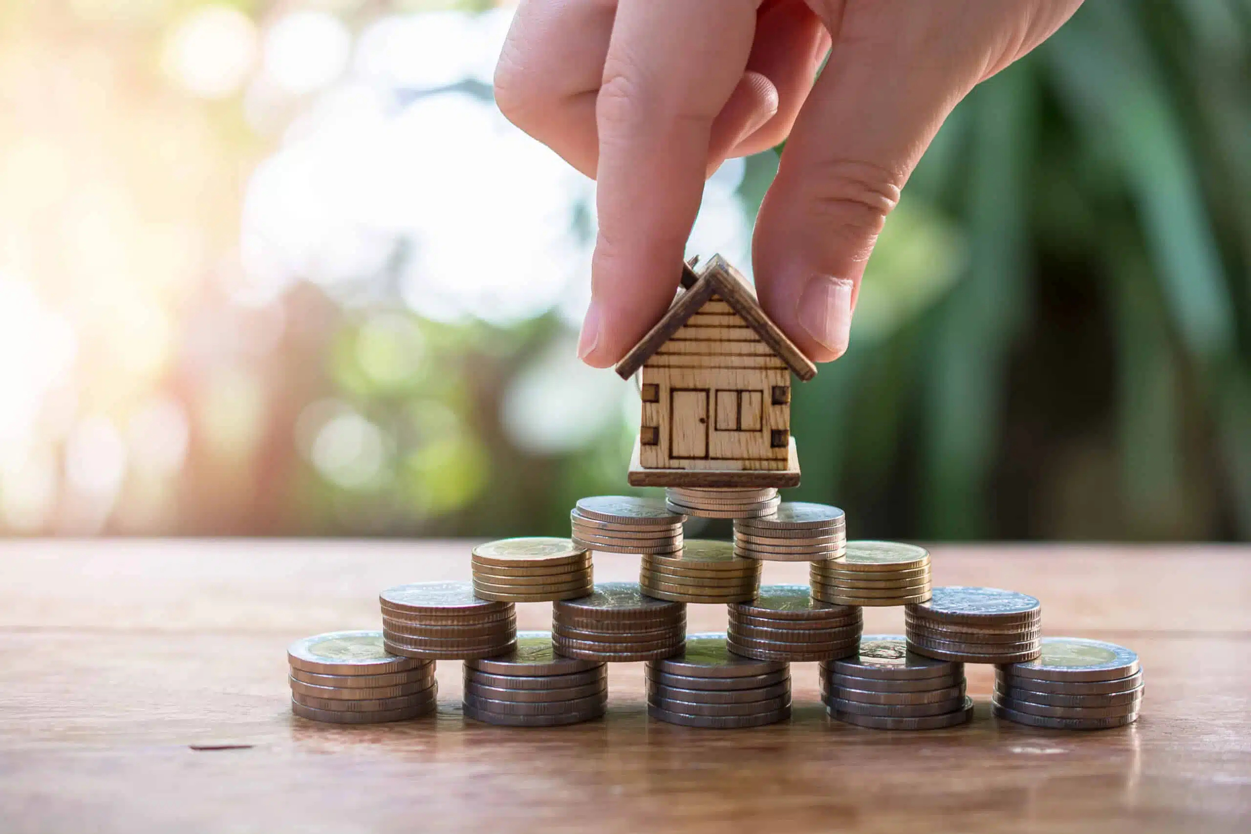 House model on stacked coins symbolising an equity release home loan